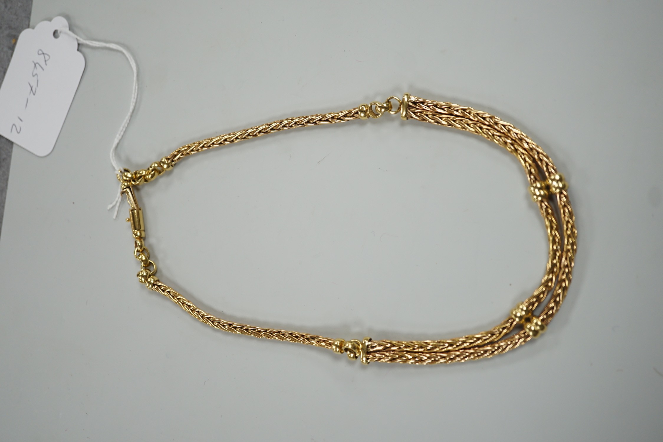 A modern continental yellow metal, single and twin strand interwoven link necklace, approximately 40cm, 44.6 grams.